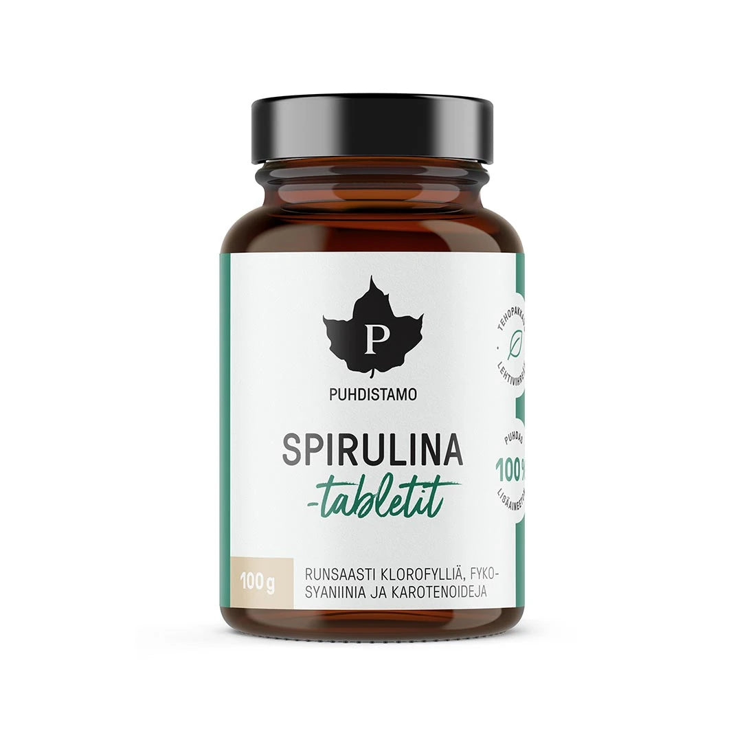 Puhdistamo Spirulinatabletit 100 g tummassa purkissa, jossa on valkoinen etiketti ja vihreitä yksityiskohtia.