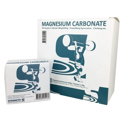 Strength Sport Nutrition Magnesium Carbonate 60 g valkoisessa paperipakkauksessa, jossa on sininen painonnostajan kuvitus.