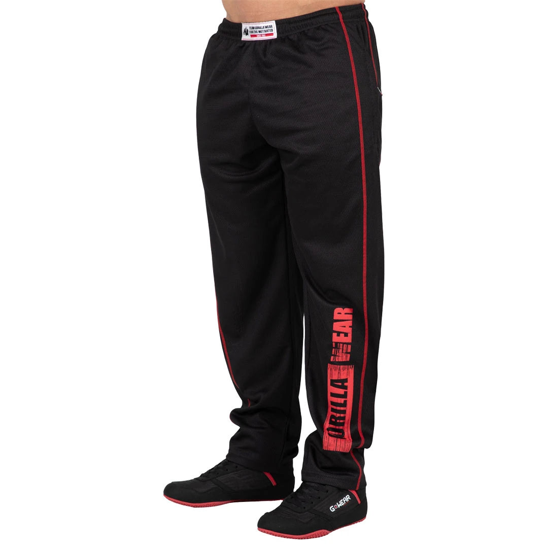 Mustat Gorilla Wear Wallace Mesh Pants Black/Red -mesh-treenihousut, joissa punaiset sivusaumat ja iso logo lahkeessa.