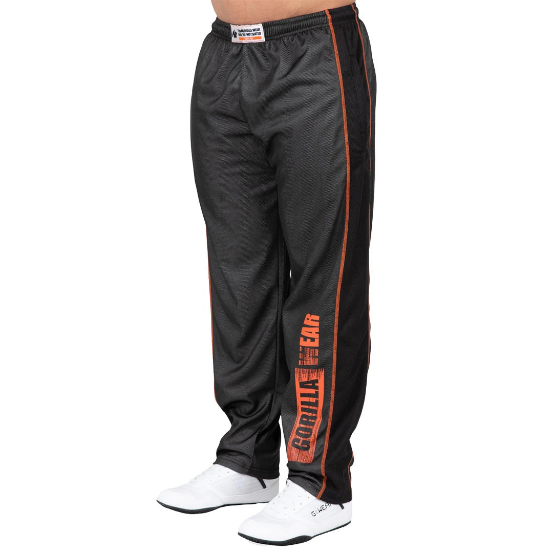 Gorilla Wear Wallace Mesh Pants Grey/Orange, tummanharmaat verkkokankaiset treenihousut oranssilla logolla.