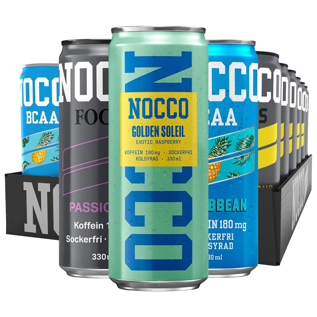 24 x NOCCO BCAA / BCAA+ / FOCUS 330 ml / NOCCO FLAK -sekoituslava värikkäitä alumiinitölkkejä mustassa pahvialustassa.