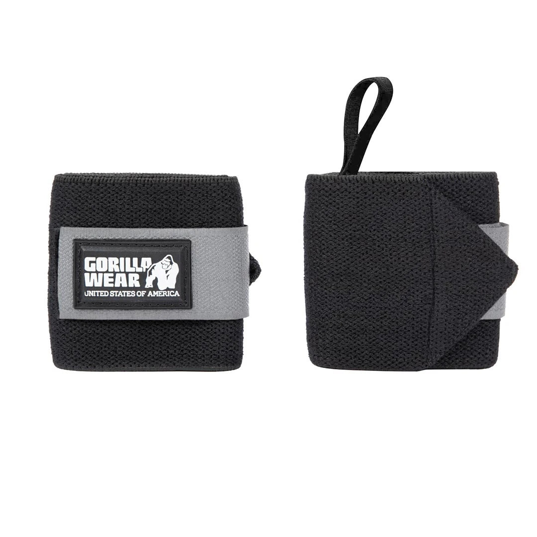 Mustat ja harmaat Gorilla Wear Wrist Wraps Basic Black/Grey -rannetuet tarrakiinnityksellä ja peukalolenkillä.