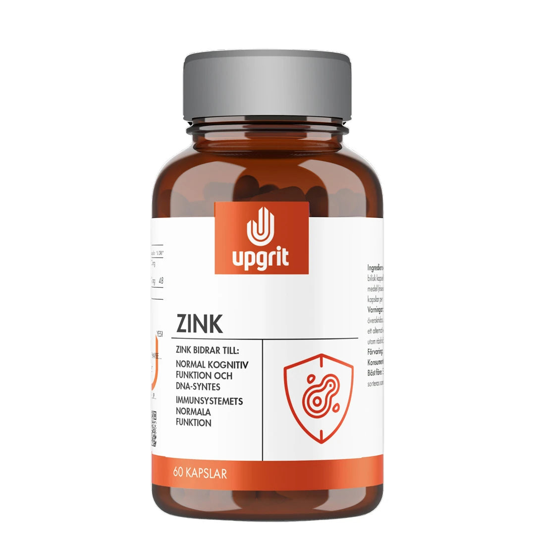 Upgrit Zink 60 caps -ravintolisä tummanruskeassa purkissa, jossa on harmaa kansi, valkoinen etiketti ja oranssi logo.