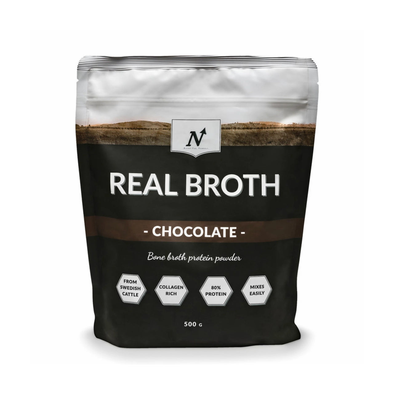 Nyttoteket Real Broth 500 g -luuliemijauhe mustavalkoisessa pussissa ruskeilla yksityiskohdilla, makuna Chocolate.