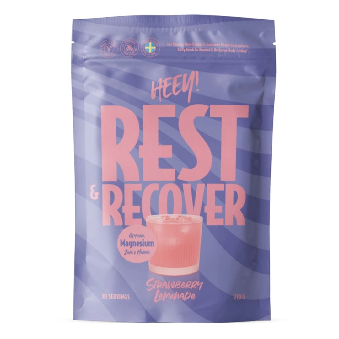 Heey! Rest & Recover Magnesium 210 g -jauhe liilassa pussissa pinkeillä yksityiskohdilla, makuna Strawberry Lemonade.