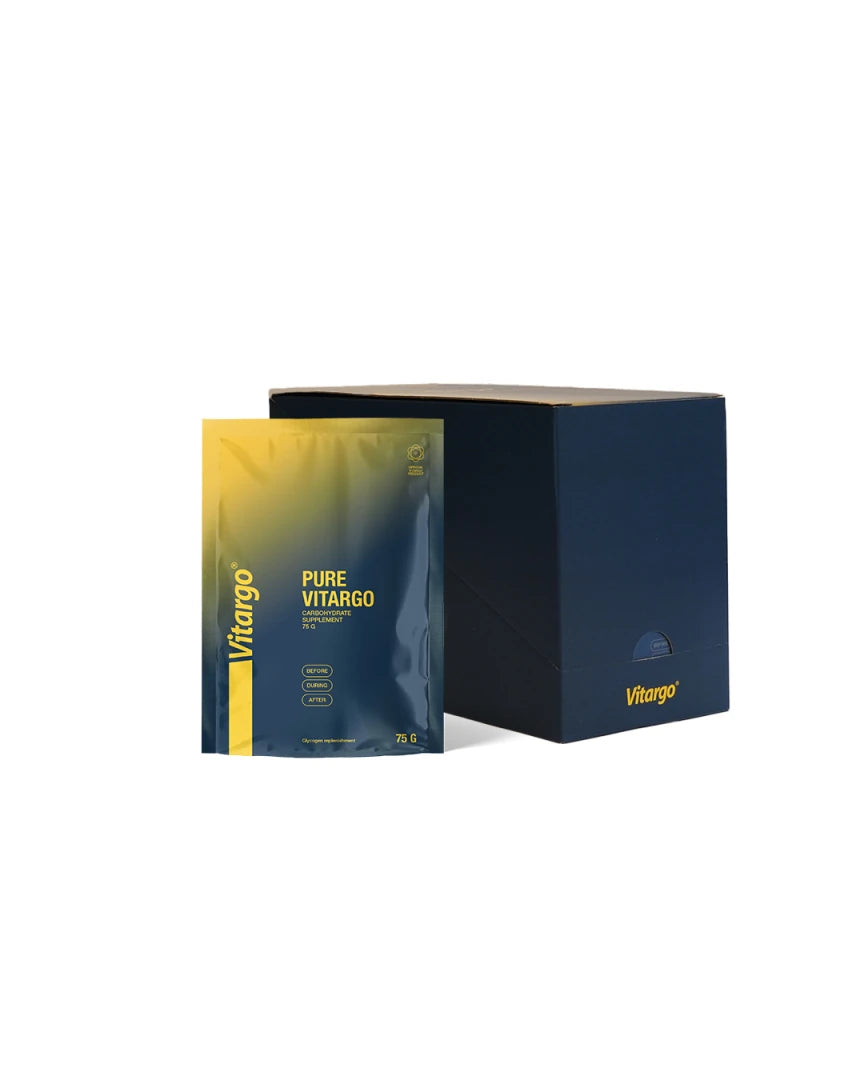 Vitargo Pure 15 x 75 g -hiilihydraatit tummansinisessä laatikossa, edessä kelta-sininen annospussi.