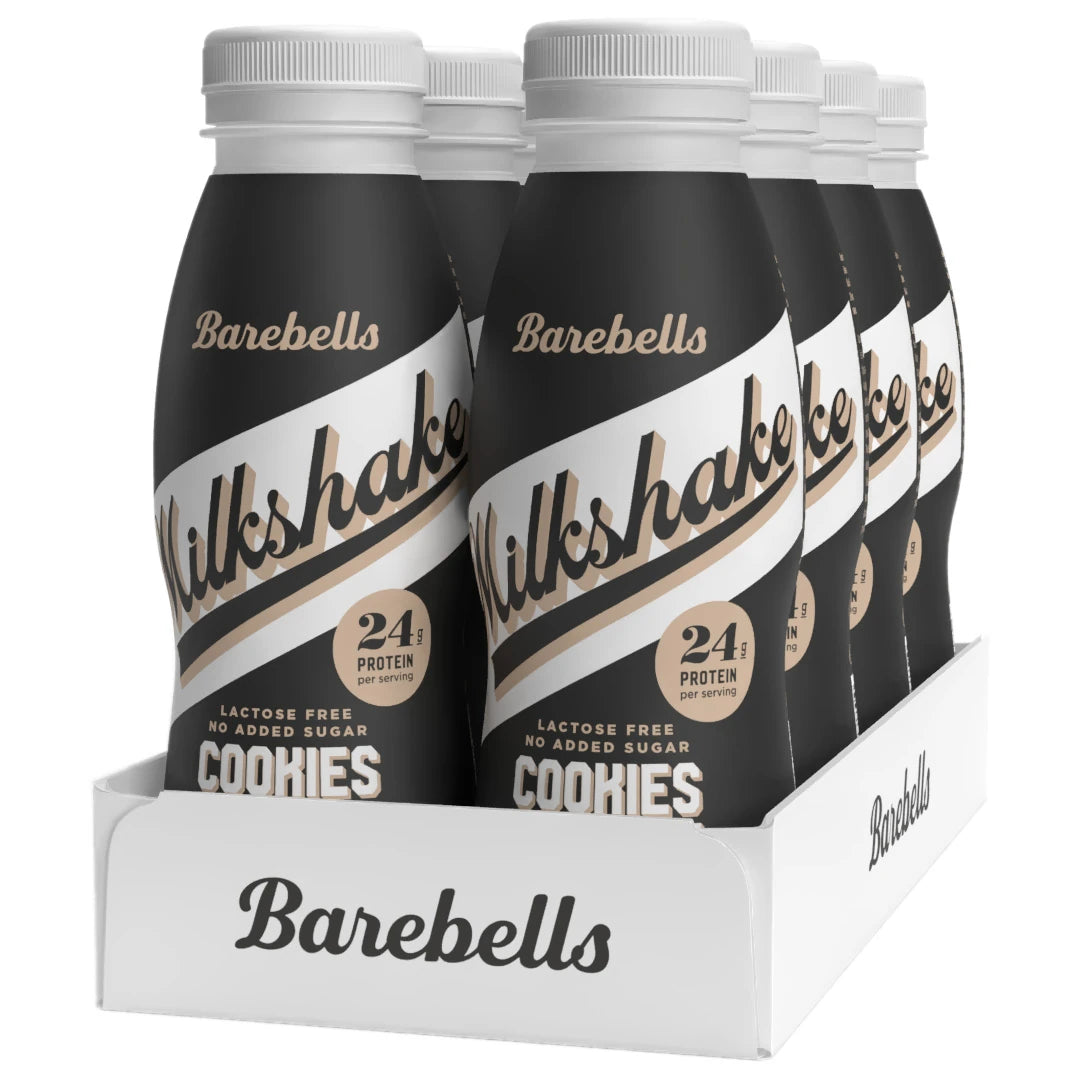 8 x Barebells Milkshake 330 ml Cookies & Cream valkoisessa laatikossa, jossa on mustia pulloja valkoisin yksityiskohdin.