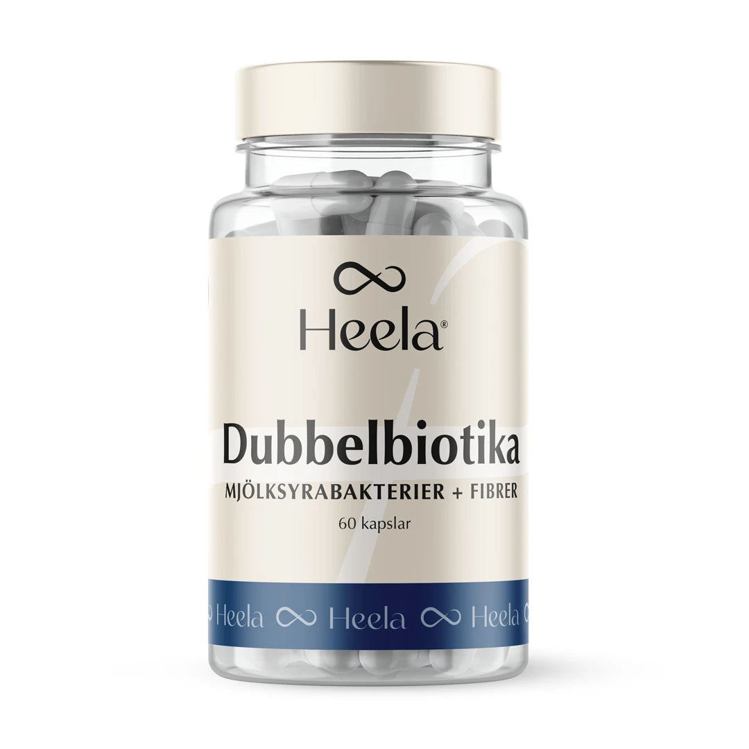 Heela Dubbelbiotika 60 caps läpinäkyvässä purkissa, jossa beige etiketti, siniset yksityiskohdat ja valkoiset kapselit.