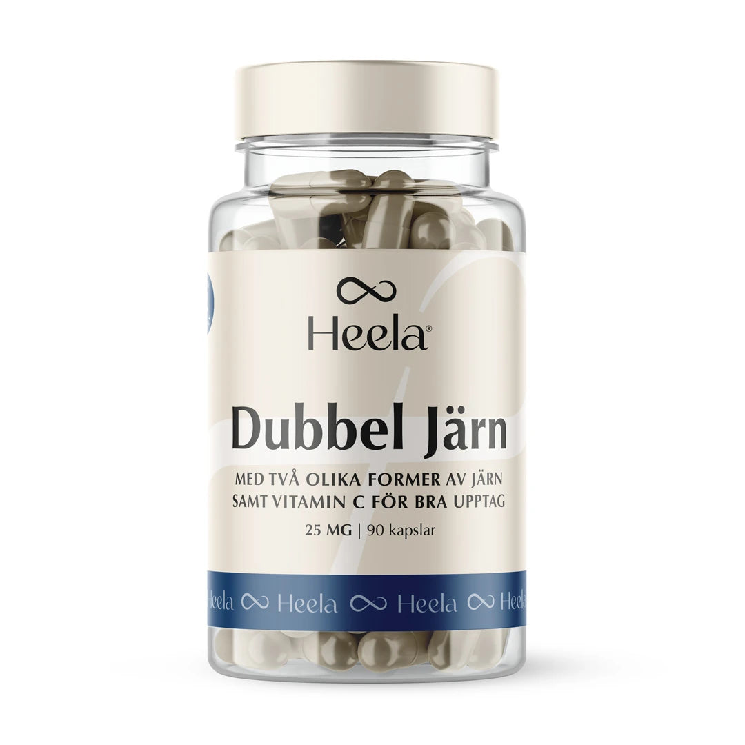 Heela Dubbel Järn 25 mg 90 caps -kapselit läpinäkyvässä muovipurkissa, jossa on beige ja sininen etiketti.