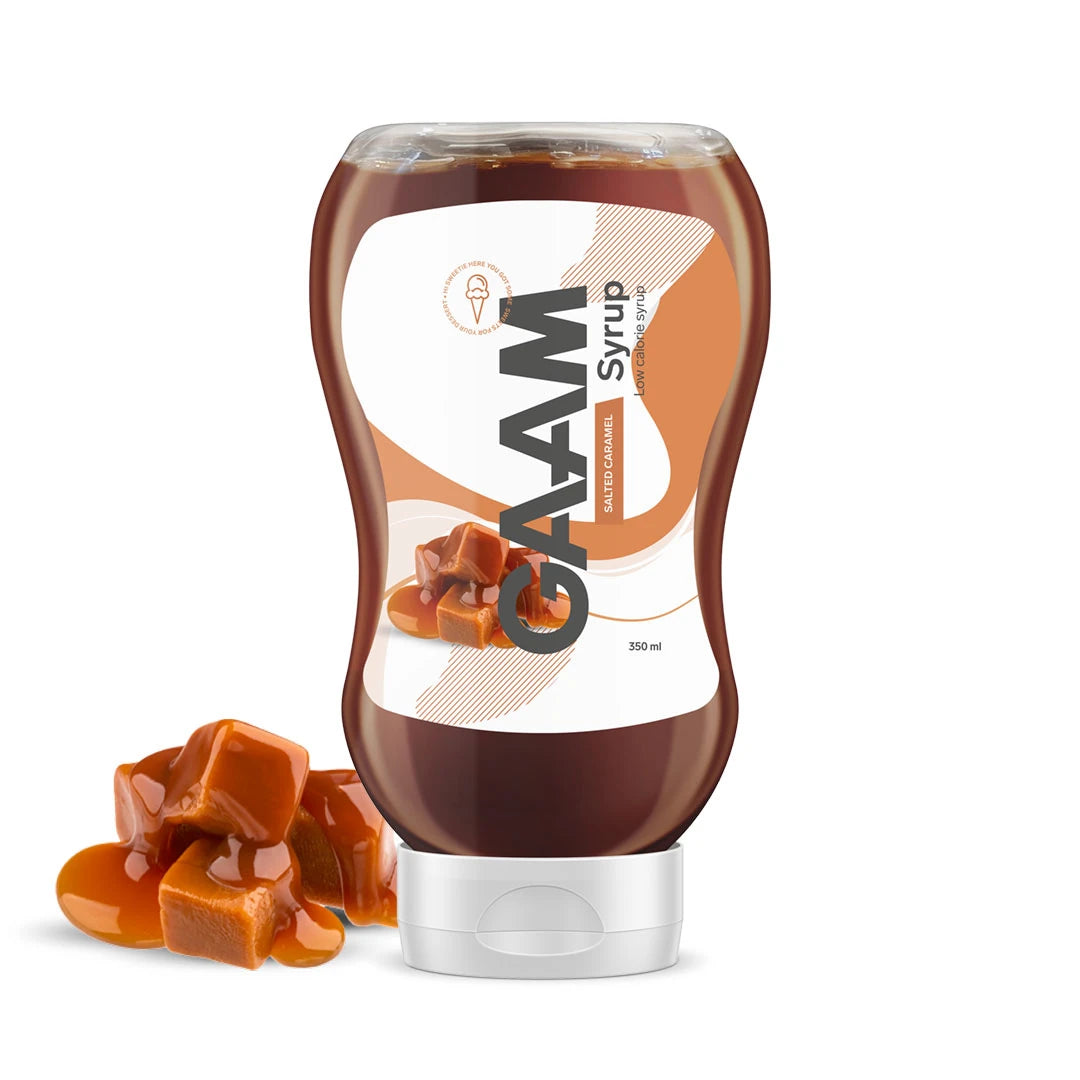 GAAM Syrup 350 ml läpinäkyvässä muovipullossa valkoisella korkilla, vierellään kinuskipaloja makuna Salted Caramel.