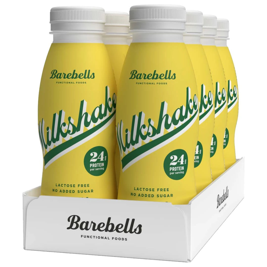 8 x Barebells Milkshake 330 ml Banana keltaisissa pulloissa vihreällä tekstillä valkoisessa laatikossa.