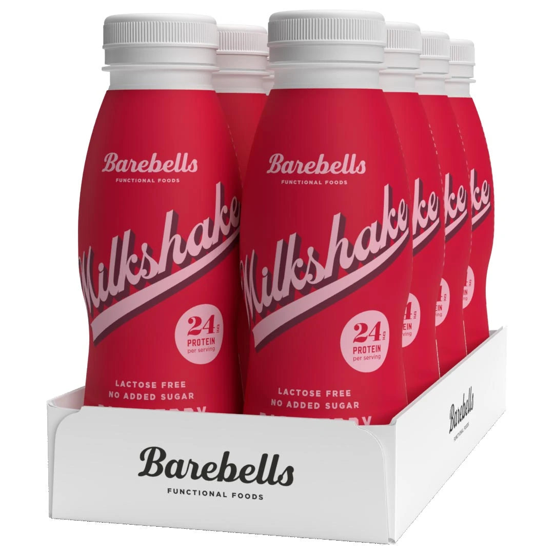 8 x Barebells Milkshake 330 ml Raspberry valkoisessa laatikossa, jossa on kahdeksan punaista vadelmanmakuista pulloa.