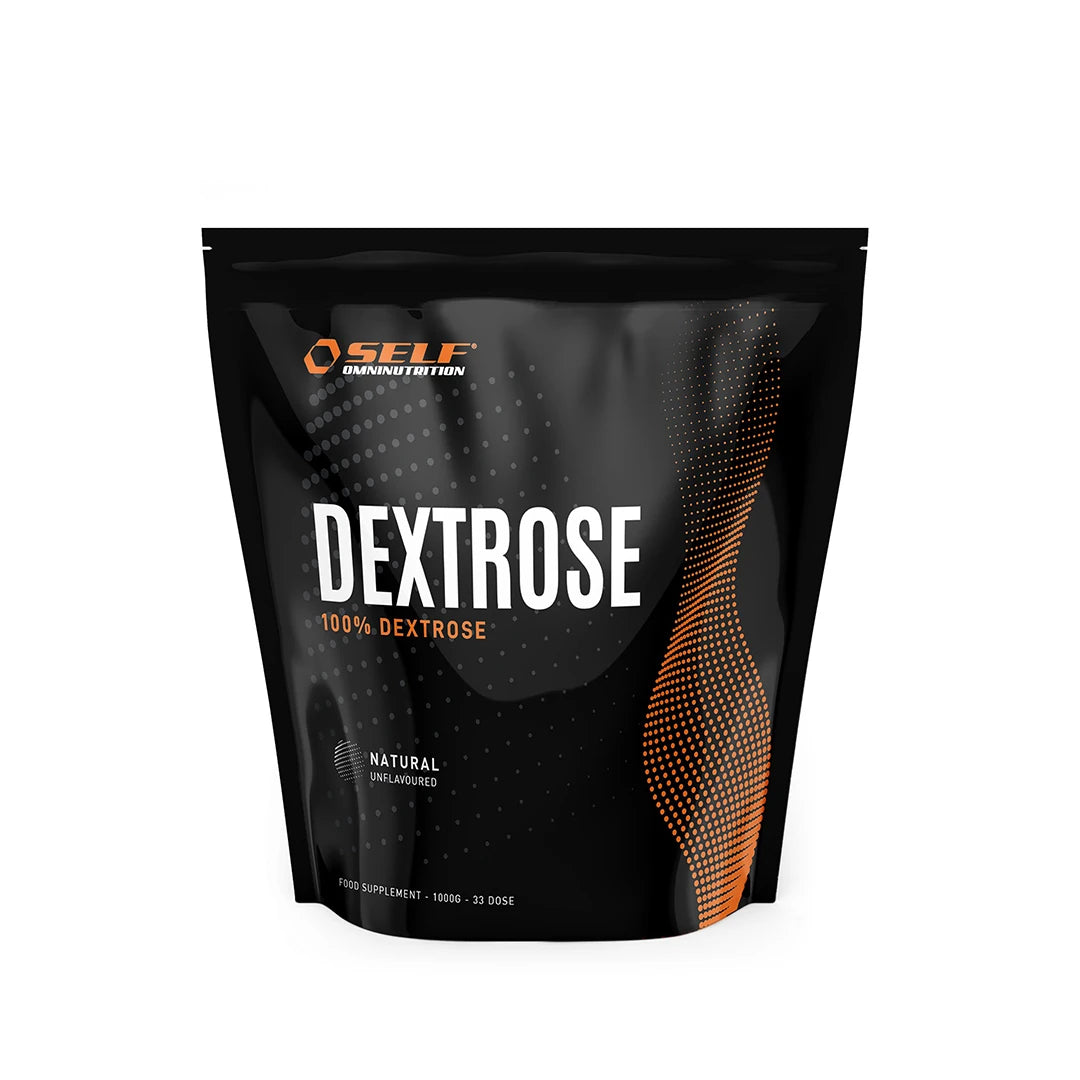 Self Omninutrition Dextrose 1 kg pakattuna mustaan pussiin, jossa on oransseja yksityiskohtia ja tekstiä hiilihydraattituotetyypille.
